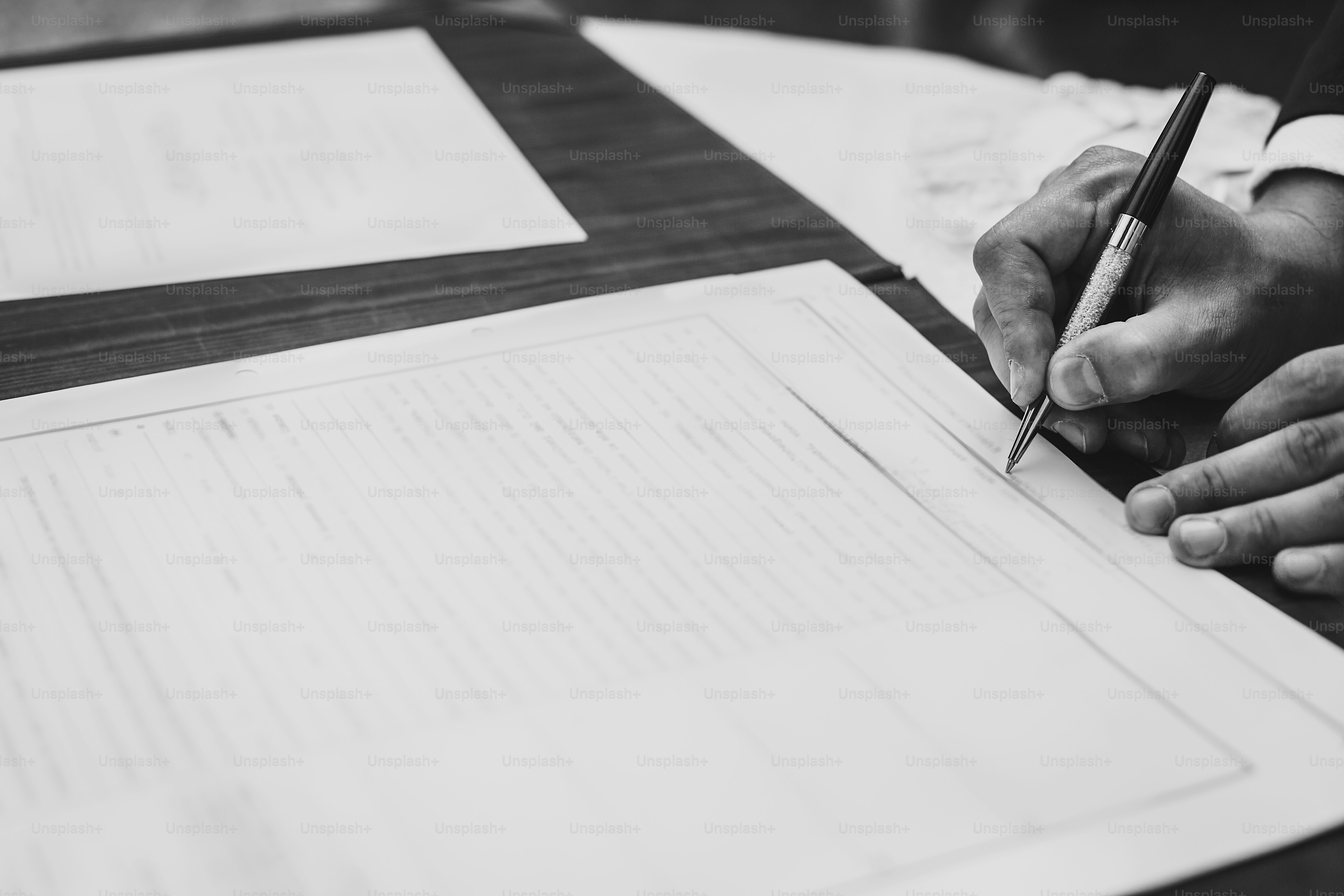 Businessman signing official document or contract. Stylish groom signing wedding register with luxury pen. Man putting signature on wedding agreement or license, legacy